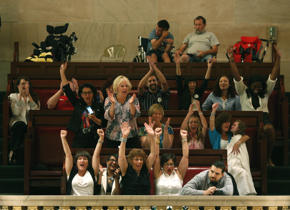 Onlookers in the gallery celebrate after the New York Senate voted to legalize medical marijuana in Albany on Friday.