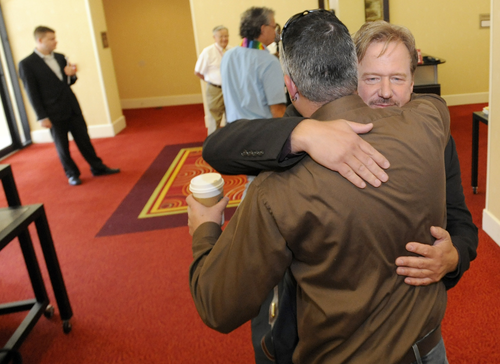 Frank Schaefer, right, a United Methodist Church pastor who was defrocked for officiating at his son’s same-sex wedding, hugs supporter Ben Overturf of Harrisburg, Pa., before a Methodist judicial panel heard the appeal of Schaefer’s defrocking Friday in Linthicum, Md.