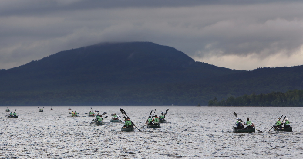 Teams paddle across Moosehead Lake toward Little Kineo Mountain at the start of the 200-mile, four-day test of endurance.