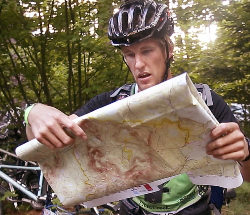 The longest journey begins with, well, a look at the map, as Staffan Björklund prepares for a 45-mile bicycle ride with his team this past Wednesday.