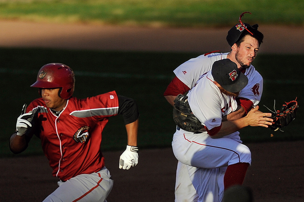 Altoona Curve baserunner Willy Garcia makes his way toward second as Sea Dogs second baseman Sean Coyle, center, and first baseman Stefan Welch, right, collide while pursuing a ground ball with one out in the seventh inning at Hadlock Field on Friday. Gabe Souza/Staff Photographer
