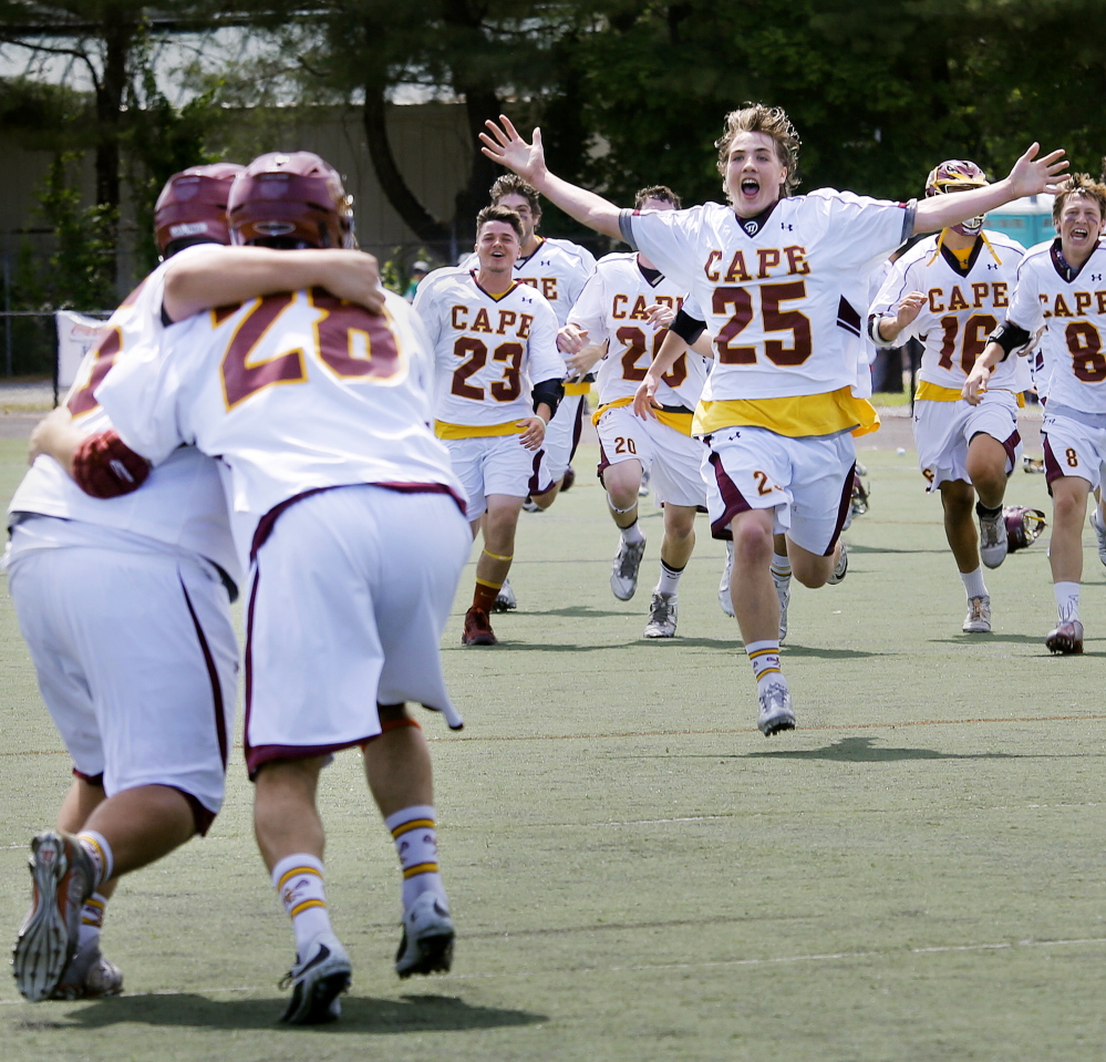 Owen Thoreck (25) and his Cape Elizabeth teammates begin their celebration after defeating Yarmouth 6-3 in the Class B boys’ lacrosse state championship game Saturday at Fitzpatrick Stadium.