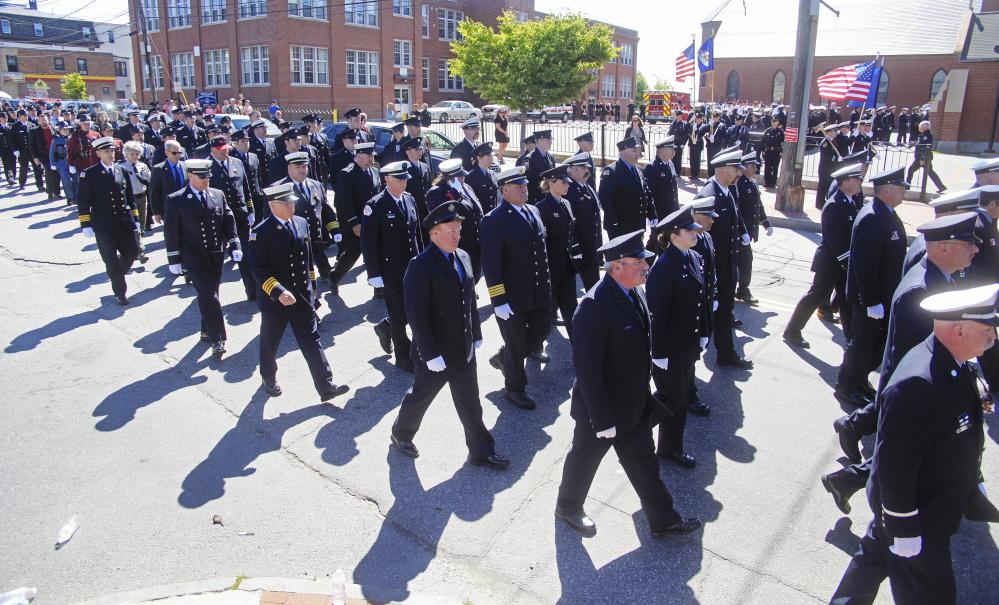 Firefighters from near and far march into the funeral service for Portland Fire Capt. Michael Kucsma at the Cathedral of the Immaculate Conception in Portland Saturday, June 21, 2014. Jill Brady/Staff Photographer