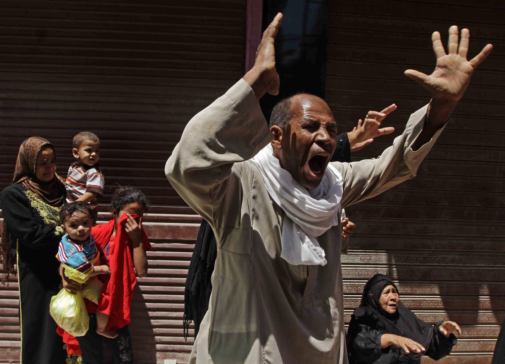 Relatives of a Muslim Brotherhood member who was sentenced to death react to the verdict outside a courtroom in Minya, Egypt, on Saturday. The Muslim Brotherhood’s Supreme Guide, Mohammed Badie, and more than 180 others were sentenced to death.