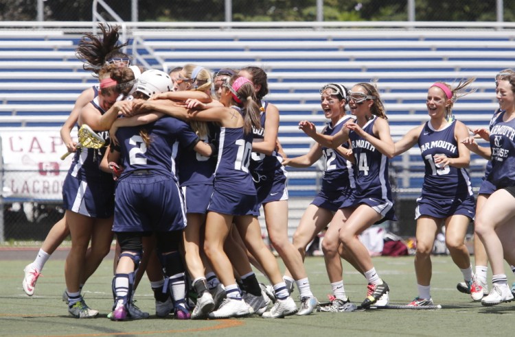  Yarmouth teammates mob goalie Mary Kate Gunville after defeating Cape Elizabeth in the Class B State Championship. 
