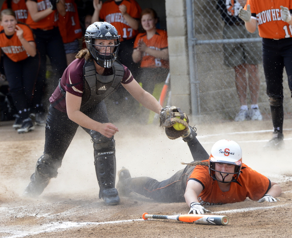 Skowhegan’s Tara Bernard slides safely into home ahead of the tag by Thornton Academy catcher Aleisha Cross, capping a four-run first inning for the Indians.