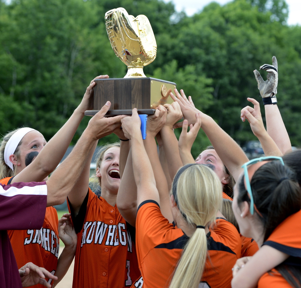 Skowhegan players raise the championship trophy after beating Thornton Academy for the Class A softball state championship at St. Joseph’s College.