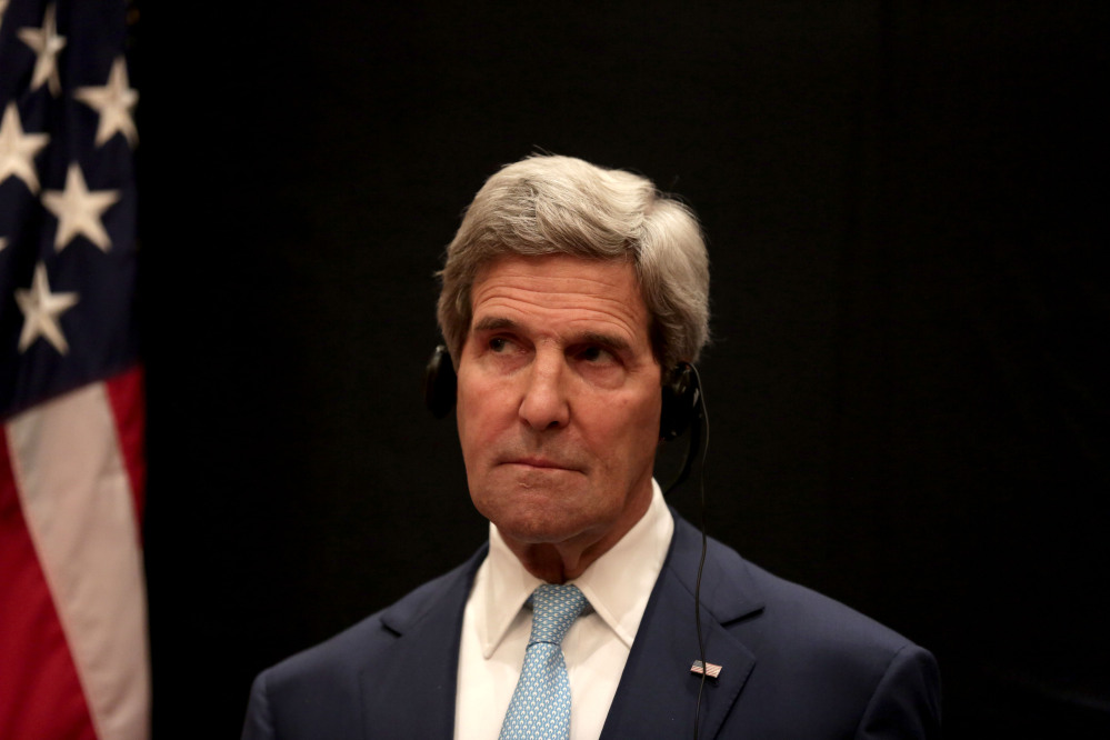U.S. Secretary of State John Kerry listens to a translation of remarks during a joint news conference with Egyptian Foreign Minister Sameh Shoukry following his meeting with Egyptian President Abdel-Fattah el-Sissi on Sunday.