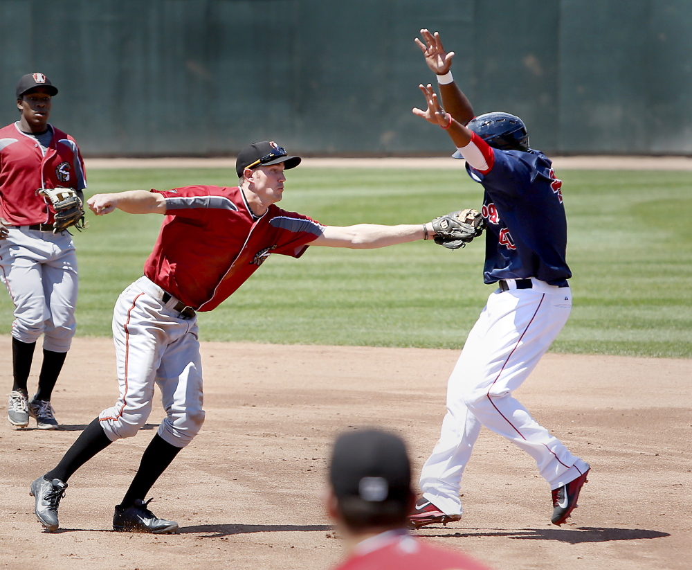 Keury De La Cruz of the Sea Dogs is tagged out on his way to second base by Kelson Brown of the Curve in the first inning of Altoona’s 5-4 win at Hadlock Field on Sunday afternoon.