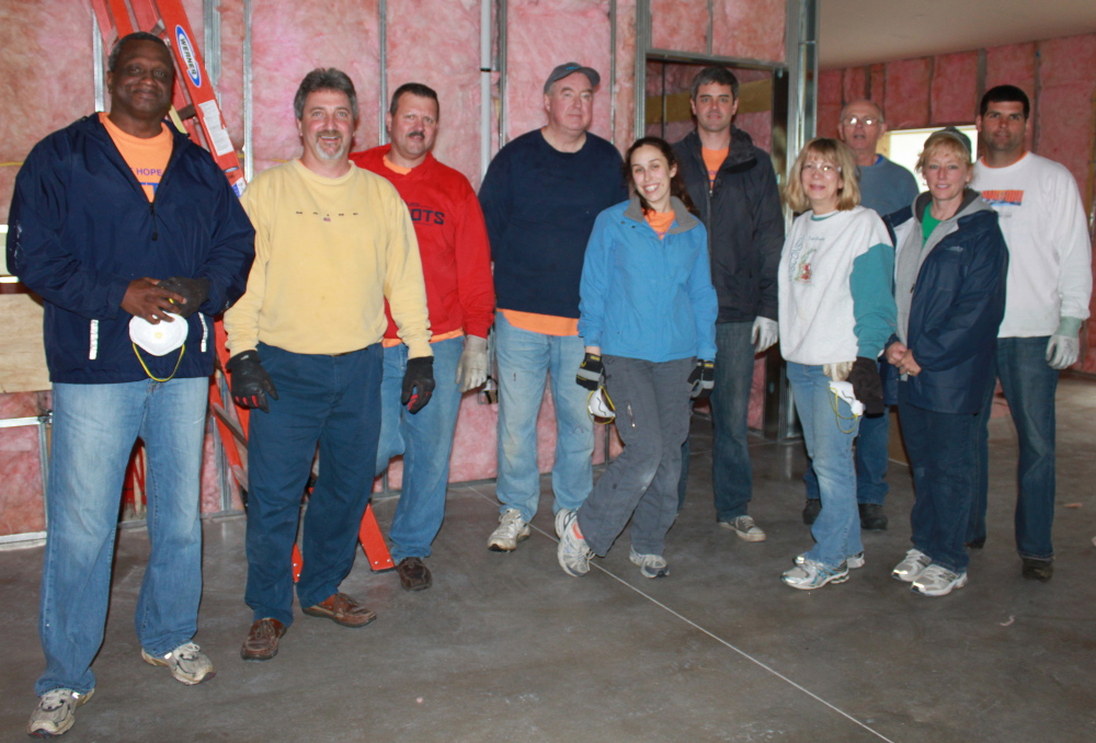 Day of Caring volunteers from Pratt & Whitney recently installed insulation at Waban's TREE Center renovation project at the Commons –to be opened as the Experiential Education Center this summer. The crew includes, from left, Mack Mann, David Cote, Ken Dickie, Dick MacDonald, Jessica Crowe, J.P. Tapley, Janet Wade-Utay, Val Grondin, Donna Labelle and Conor Tracy. Photo courtesy Selena Brock