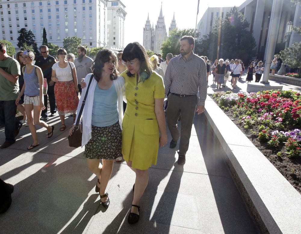Kate Kelly, right, walks with a supporter after addressing her supporters at the Church Office Building of the Church of Jesus Christ of Latter-day Saints during a vigil Sunday, June 22, 2014, in Salt Lake City. Kelly was shocked to find out earlier this month from her bishop that she is facing excommunication from The Church of Jesus Christ of Latter-day Saints, of which she is a lifelong member.