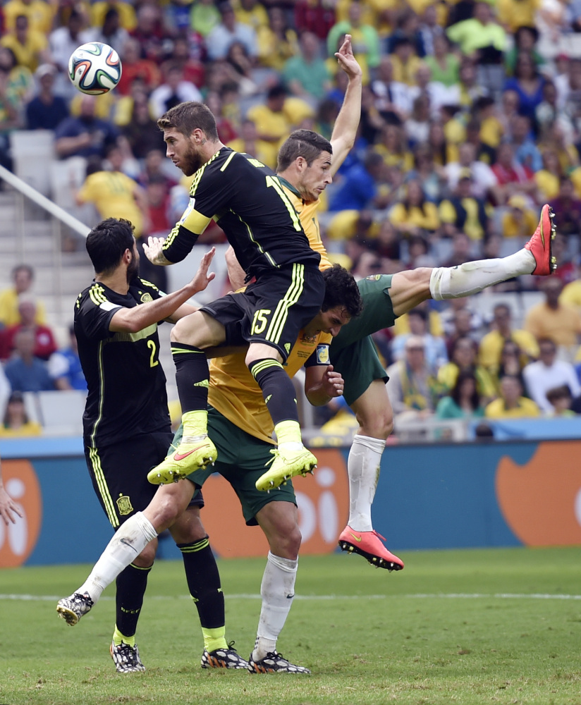 Spain’s Sergio Ramos wins a header during the group B World Cup soccer match between Australia and Spain at the Arena da Baixada in Curitiba, Brazil, Monday, June 23, 2014.