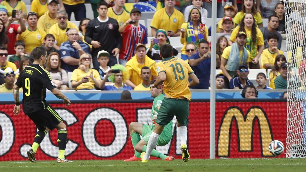 Spain’s Fernando Torres, left, scores his side’s second goal during the group B World Cup soccer match between Australia and Spain at the Arena da Baixada in Curitiba, Brazil, Monday, June 23, 2014.