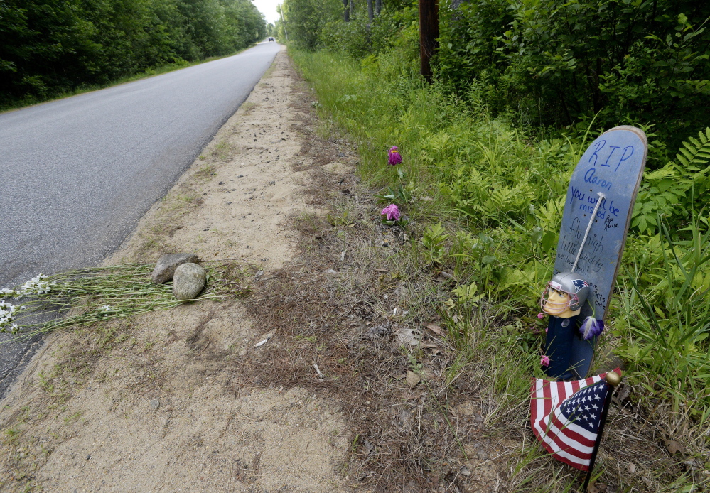 A makeshift memorial stands along Long Swamp Road in Lebanon on Monday. Police have identified a man who was found fatally stabbed in Lebanon on Saturday as Aaron Wilkinson.
Shawn Patrick Ouellette/Staff Photographer