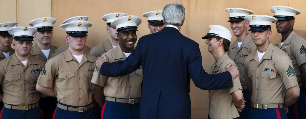 U.S. Secretary of State John Kerry greets U.S. Marines as he arrives at the U.S. Embassy in Baghdad, Iraq, on Monday. Kerry said the fate of Iraq is largely dependent on whether its leaders meet a deadline for starting to form a new government.