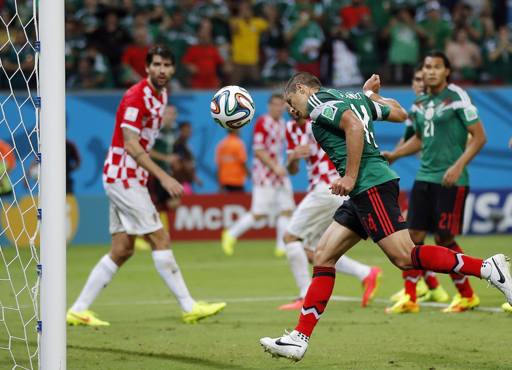 Mexico’s Javier Hernandez scores during the group A World Cup soccer match between Croatia and Mexico at the Arena Pernambuco in Recife, Brazil, Monday, June 23, 2014.