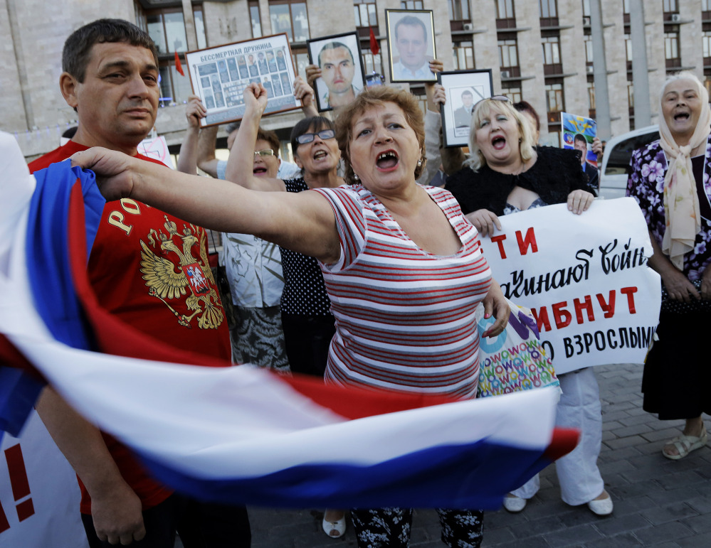 Pro-Russian demonstrators shout slogans in Donetsk, eastern Ukraine, Monday. 