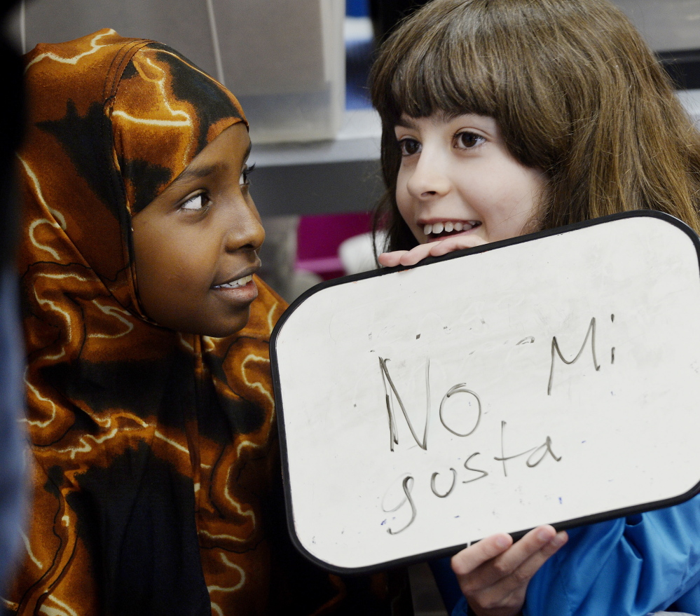 Samira Yusuf, left, and Altana Johnson work together during Spanish class at Lyseth Elementary School in Portland.