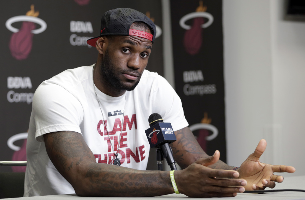Miami Heat’s LeBron James gestures as he answers a question during a news conference in Miami, Tuesday.