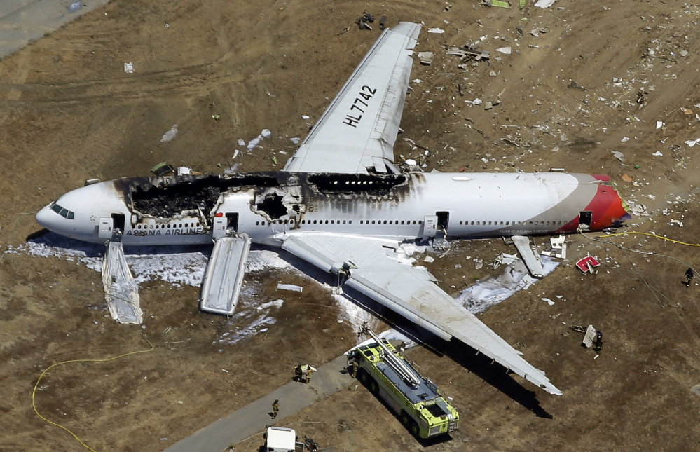 In this July 6, 2013 aerial file photo, the wreckage of Asiana Flight 214 lies on the ground after it crashed at the San Francisco International Airport in San Francisco.