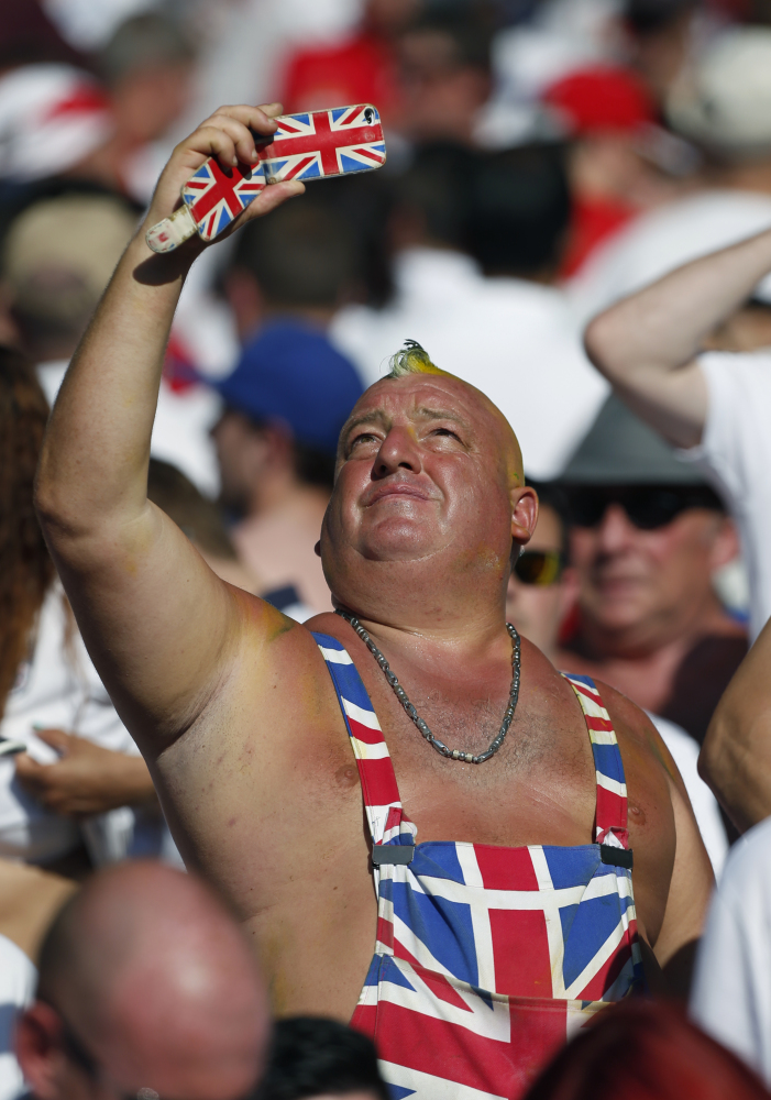 An England supporter takes a photo after the group D World Cup soccer match between Costa Rica and England at the Mineirao Stadium in Belo Horizonte, Brazil, Tuesday, June 24, 2014.