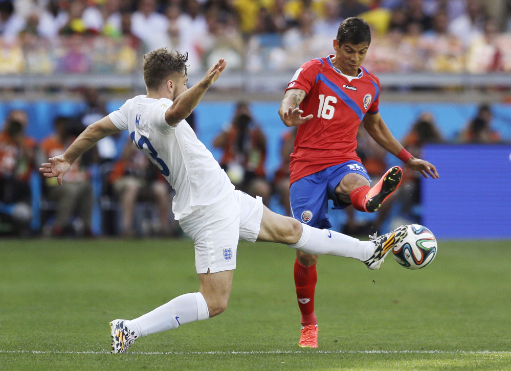 England’s Luke Shaw, left, challenges Costa Rica’s Cristian Gamboa during the group D World Cup soccer match between Costa Rica and England.