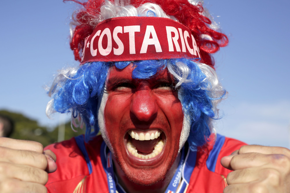 A supporter celebrates Costa Rica’s finishing first in what many considered the World Cup’s toughest group after a 0-0 draw against England.