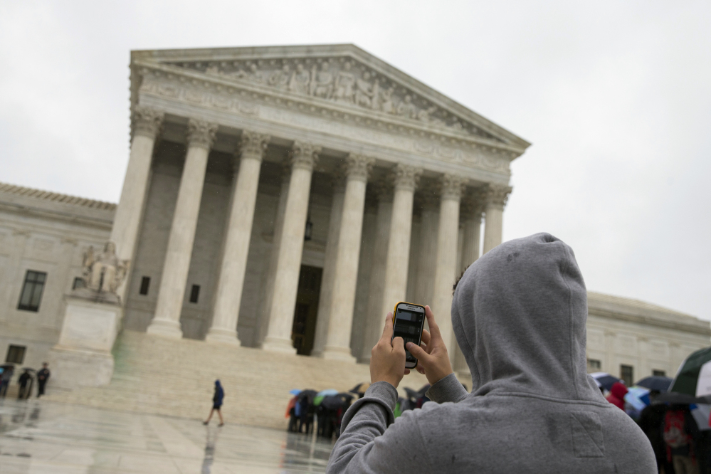 A unanimous Supreme Court says police may not generally search the cellphones of people they arrest without first getting search warrants. The justices say cellphones are powerful devices unlike anything else police may find on someone they arrest.