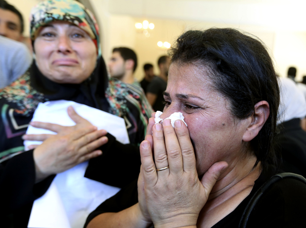 Relatives of Abdul-Karim Hodroj, a security officer who was killed Tuesday by a car bomb, weep during his funeral procession in the southern suburb of Beirut, Lebanon, on Wednesday. Violence continued Wednesday when a suspect blew himself up in his hotel room.
