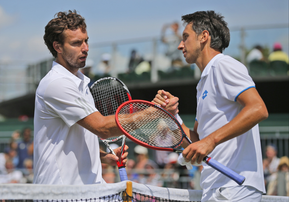 Sergiy Stakhovsky of Ukraine, right, shakes hands with Ernests Gulbis of Latvia following their men’s singles match at the All England Lawn Tennis Championships in Wimbledon, London, on Wednesday.