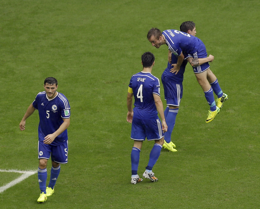 Bosnia defender Avdija Vrsajevic, right, celebrates his goal with his teammates during the second half of a group F World Cup soccer match against Iran.