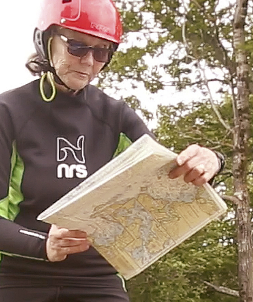Deb Walters looks at a chart before paddling at Birch Point State Park in Owls Head. Her yearlong trip will start in Yarmouth and end in Guatemala City.