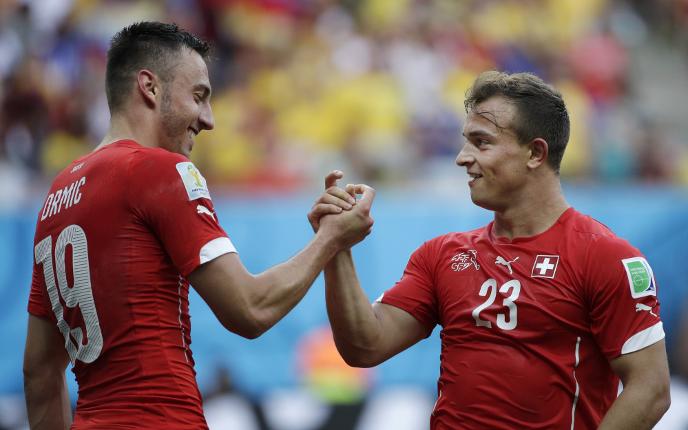 Switzerland’s Xherdan Shaqiri, right, celebrates with teammate Josip Drmic after scoring his side’s second goal during the group E World Cup soccer match between Honduras and Switzerland at the Arena da Amazonia in Manaus, Brazil, on Wednesday.