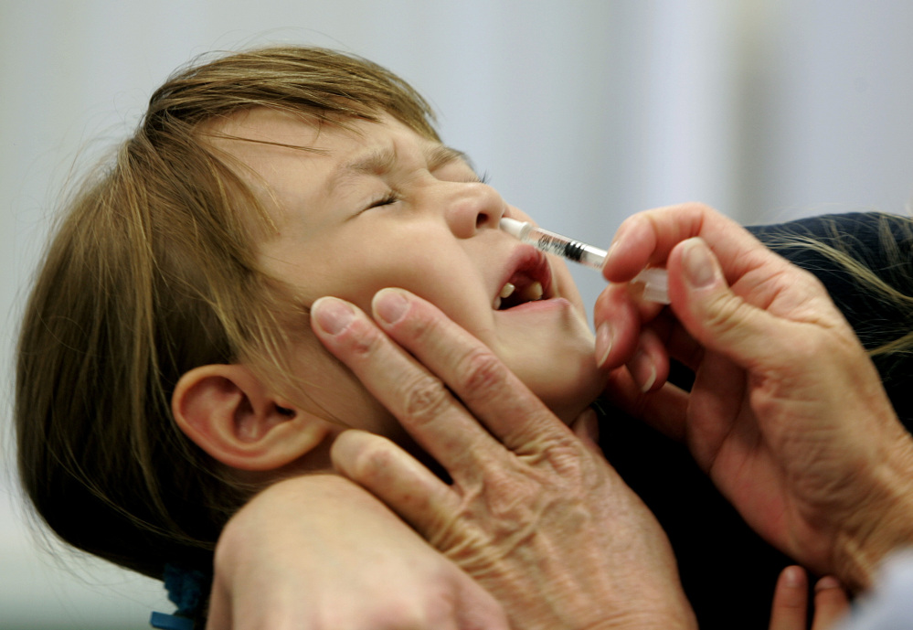 A child reacts as she is given a dose of FluMist influenza vaccine. A federal advisory panel recommends the nasal spray over shots for healthy young children.
The Associated Press