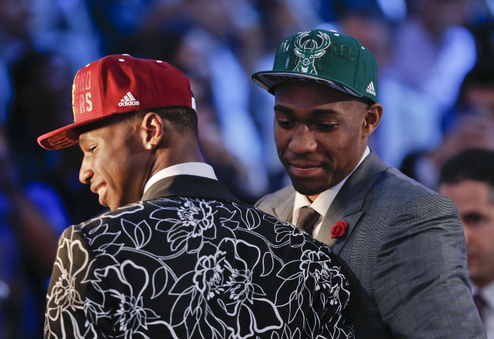 Andrew Wiggins, left, and Jabari Parker stop for television interviews after being selected as the top two picks in the 2014 NBA draft Thursday in New York. Wiggins was selected No. 1 by the Cleveland Cavaliers, and Parker was chosen No. 2 by the Milwaukee Bucks.