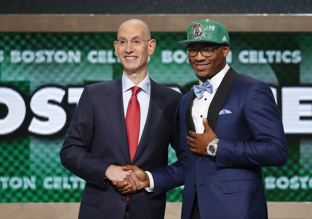 Oklahoma State’s Marcus Smart, right, poses for a photo with NBA commissioner Adam Silver after being selected sixth overall by the Boston Celtics during the 2014 NBA draft Thursday in New York.