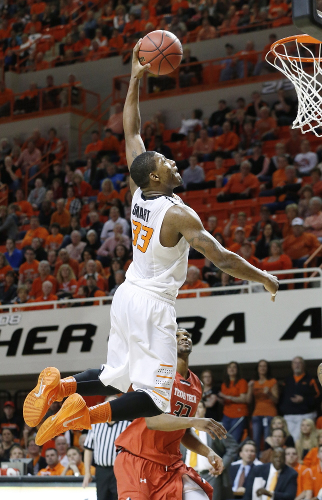 Oklahoma State guard Marcus Smart goes up for a dunk in front of Texas Tech forward Jordan Tolbert in a February game in Stillwater, Okla.