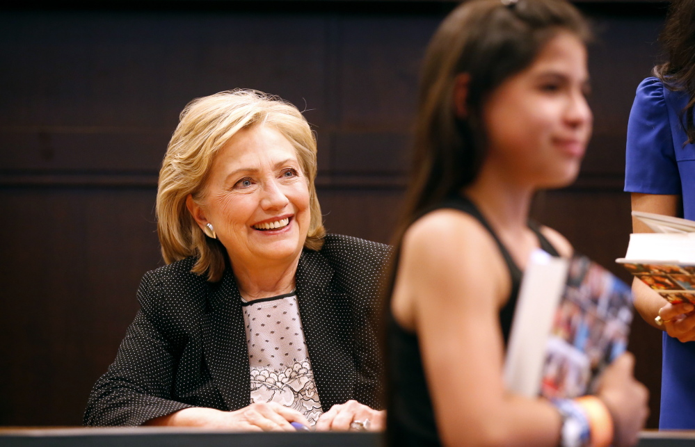 Former Secretary of State Hillary Rodham Clinton smiles during a book signing for her book “Hard Choices” at a Barnes & Noble bookstore in Los Angeles on June 19.