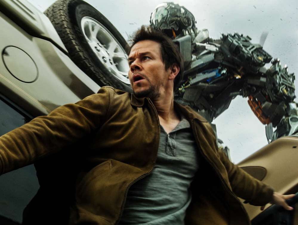 Mark Wahlberg as Cade Yeager and the alien robot bounty hunter Lock Down in “Transformers: Age of Extinction.”