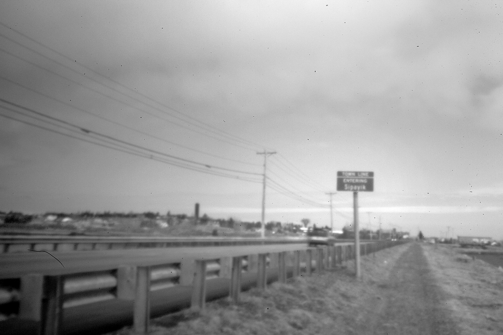 Captured in the early morning through the aperture of a pinhole camera recently, this stretch of road leads into Pleasant Point Indian Reservation, where a menacing situation developed late in 1965, when out-of-state hunters clashed with the native residents.