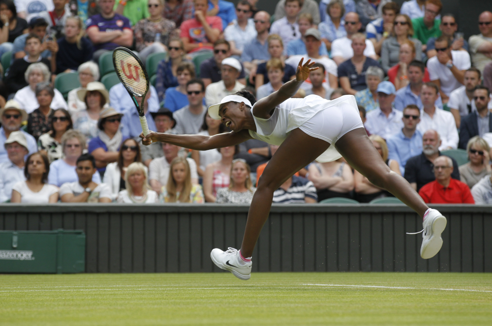 Venus Williams of U.S. reaches for a return to Petra Kvitova of the Czech Republic during their women’s singles match in Wimbledon, London, Friday, June 27, 2014.