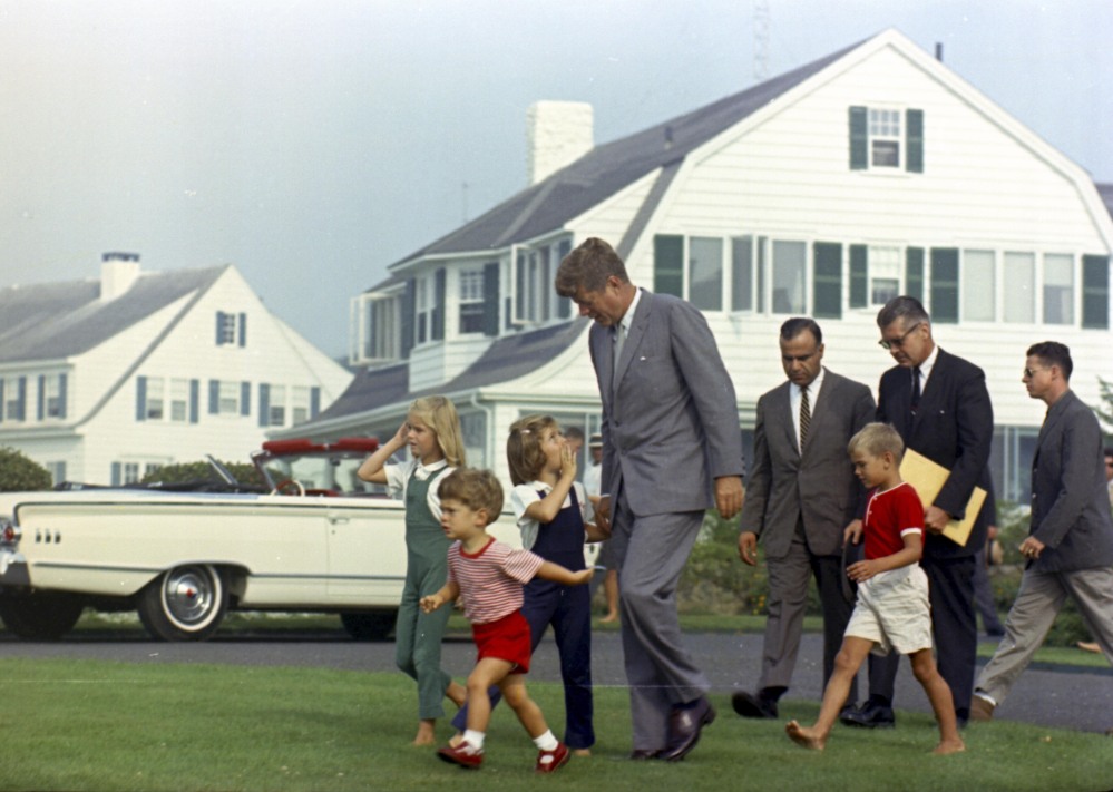 President Kennedy approaches a helicopter in Hyannis Port, Mass., on Aug. 26, 1963. With him are, from left: Sydney Lawford, John F. Kennedy Jr., Caroline Kennedy, Secret Service agent Sam Sulliman, David Kennedy, and agents Jerry Behn and Tom Wells.
