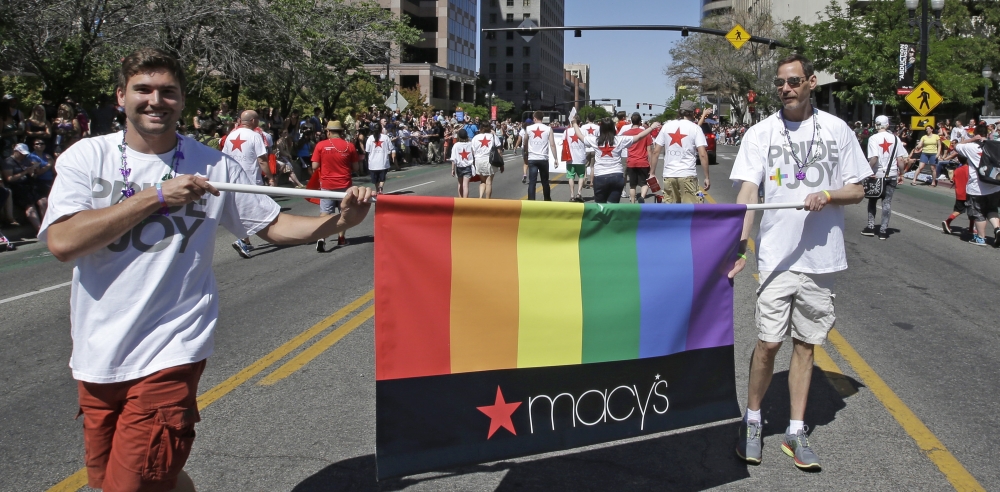Workers carry a Macy’s banner during the gay pride parade in Salt Lake City this month. Corporations such as Starbucks, Delta Air Lines and General Motors have increased visibility at pride events around the country this summer.