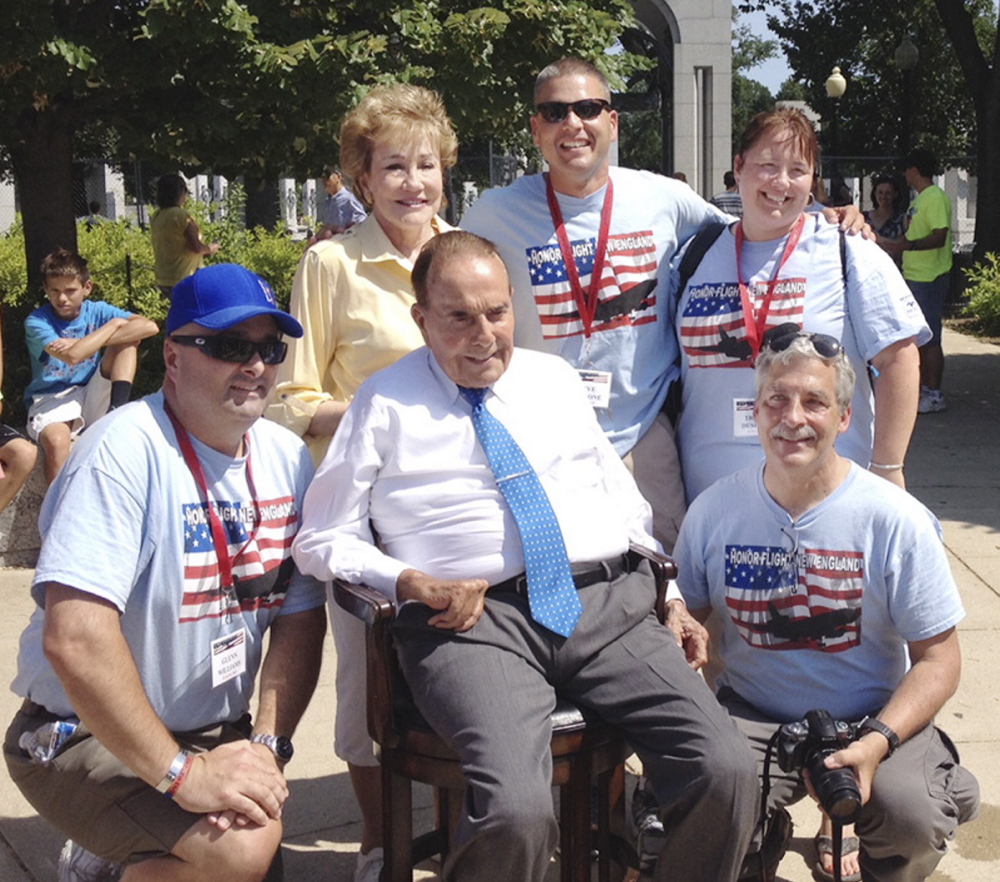 Bob and Elizabeth Dole meet Saturday with Honor Flight New England officials, including the group’s founder, Joe Byron, right, at the World War II Memorial in Washington.