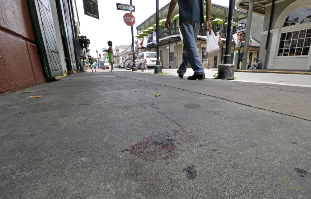 Blood stains are seen on the sidewalk at the scene of a shooting that happened early Sunday morning on Bourbon Street in New Orleans. Nine people were injured, one seriously, according to New Orleans Police.