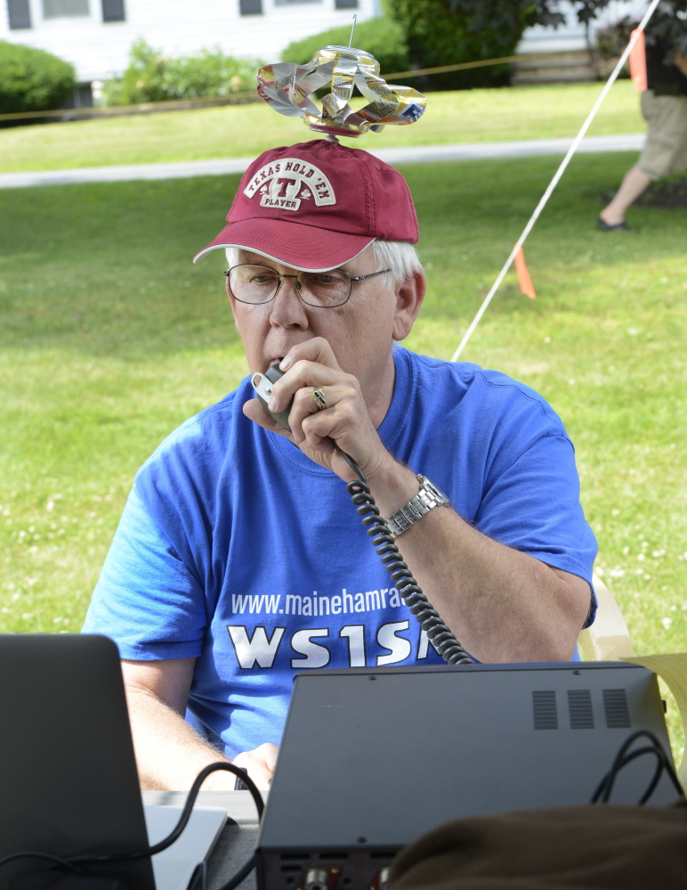 Frank Krizan of Garland, Texas, who spends his summers in Maine, makes a call during a local ham radio group event Saturday at a Scarborough campground.