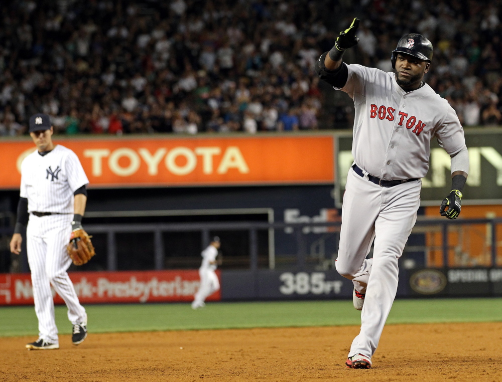 Red Sox designated hitter David Ortiz celebrates while rounding the bases after hitting a three-run home run against the New York Yankees in the third inning at Yankee Stadium on Sunday. Adam Hunger/USA Today 