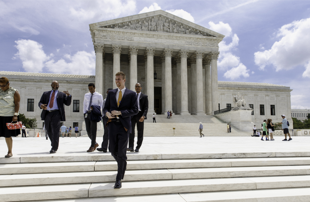 People leave the Supreme Court in Washington, Thursday, June 26, 2014, in the final days of its term.
