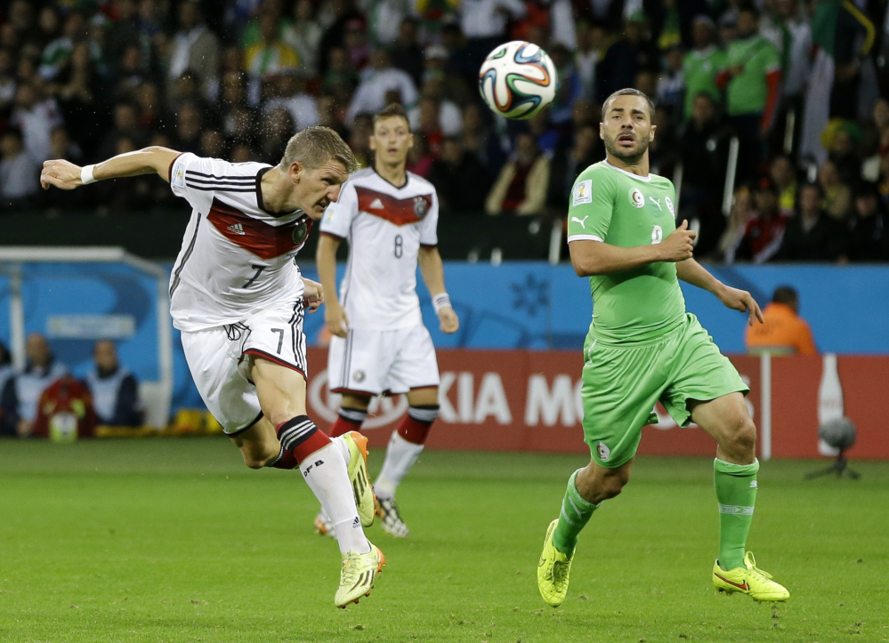 Germany’s Bastian Schweinsteiger, left, heads the ball at the Algerian goal during the World Cup round of 16 soccer match between Germany and Algeria in Porto Alegre, Brazil, Monday, June 30, 2014.