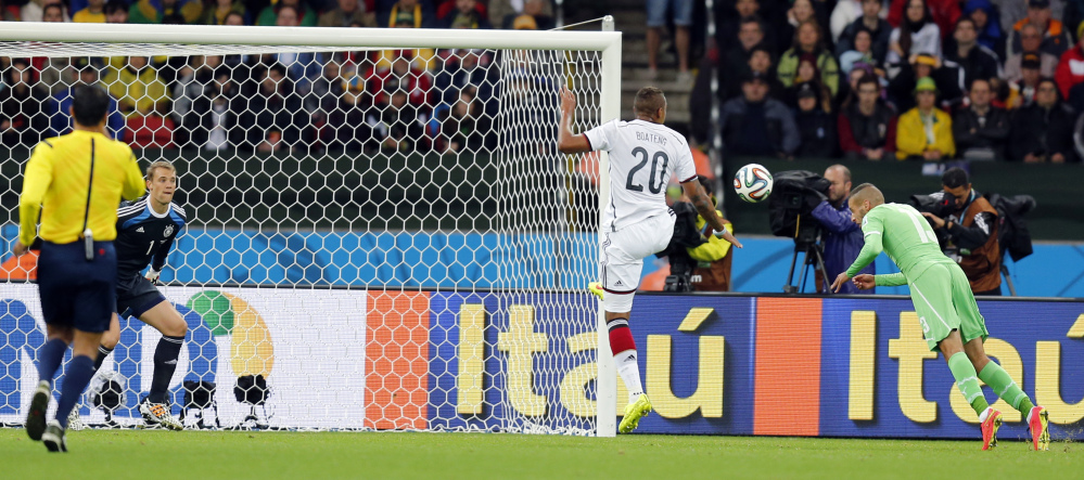 Algeria’s Islam Slimani, right, scores a goal past Germany’s goalkeeper Manuel Neuer which was disallowed during the World Cup round of 16 soccer match.